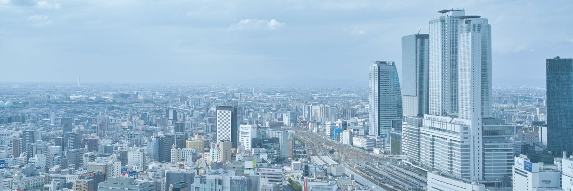 緑と都心の街並みを望む、明るい住まいのイメージ